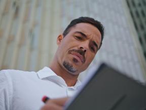 A man writing on a clipboard.