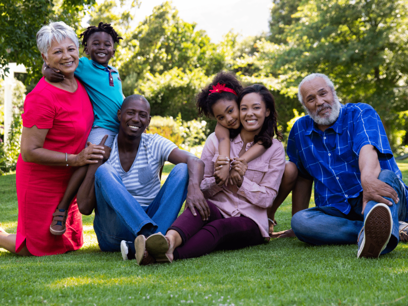 Smiling multiracial and multigenerational group on lawn
